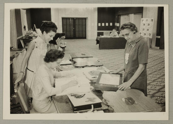 Gilchrist, Riley, and Unidentified at Convention Scrapbook Display Photograph 2, July 7-12, 1968 (image)