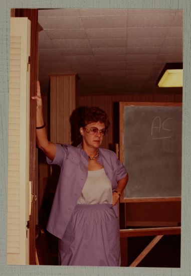 Linda Litter by Chalkboard at Convention Photograph, June 30-July 5, 1984 (image)