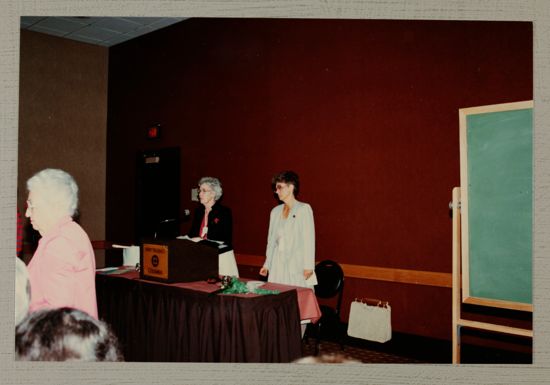 Unidentified Phi Mu and Linda Litter at Podium During Convention Photograph, June 30-July 5, 1984 (image)