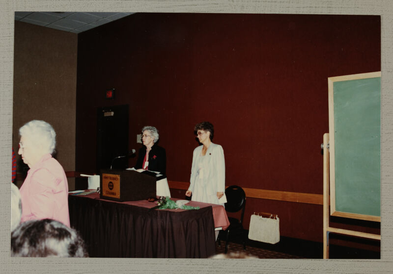 Unidentified Phi Mu and Linda Litter at Podium During Convention Photograph, June 30-July 5, 1984 (Image)