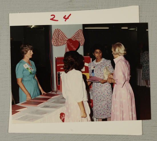 Annadell Lamb Autographing Phi Mu History Books at Convention Photograph 1, July 6-10, 1986 (image)