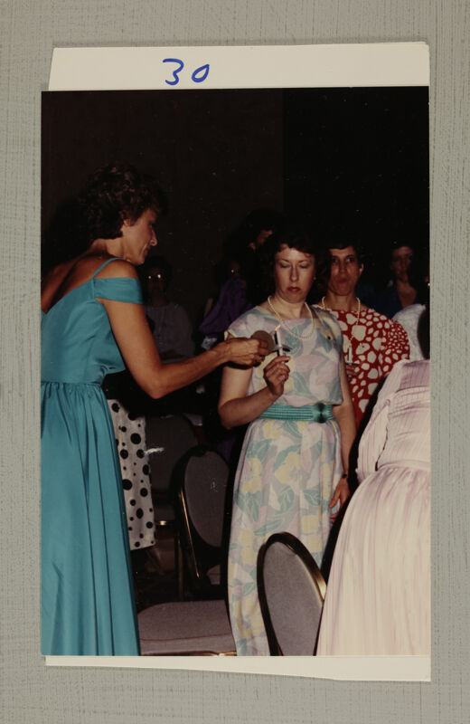 Pam Wadsworth Lighting Candle at Convention Banquet Photograph 2, July 6-10, 1986 (Image)