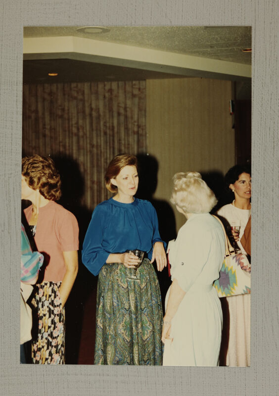 Cathy Moore Talking With Phi Mus at Convention Reception Photograph, July 6-10, 1986 (Image)