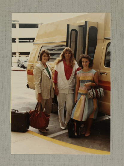 Three Convention Attendees by Airport Shuttle Photograph, July 1-5, 1988 (image)