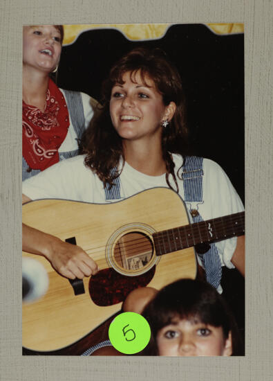 Washboard Band Member with Guitar at Convention Photograph, July 1-5, 1988 (image)