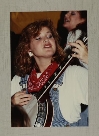 Washboard Band Member with Banjo at Convention Photograph, July 1-5, 1988 (image)