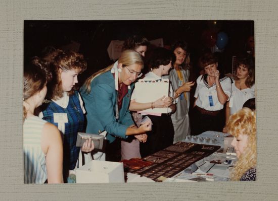 Phi Mus Looking at Jewelry Display at Convention Photograph, July 6-9, 1990 (image)