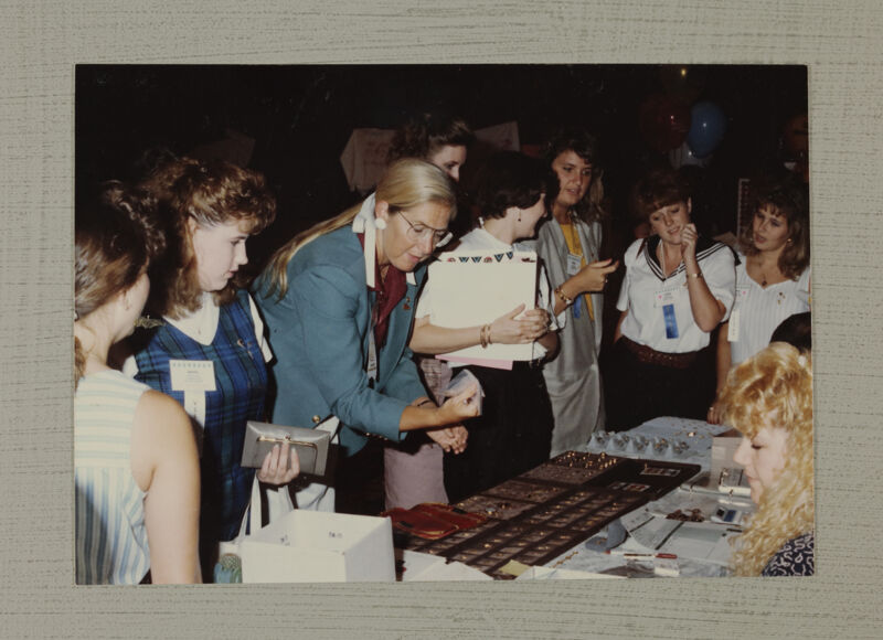 Phi Mus Looking at Jewelry Display at Convention Photograph, July 6-9, 1990 (Image)