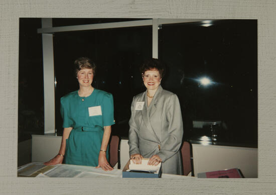 Lucy Stone and Kathie Garland at Convention Table Photograph, July 1-4, 1994 (image)