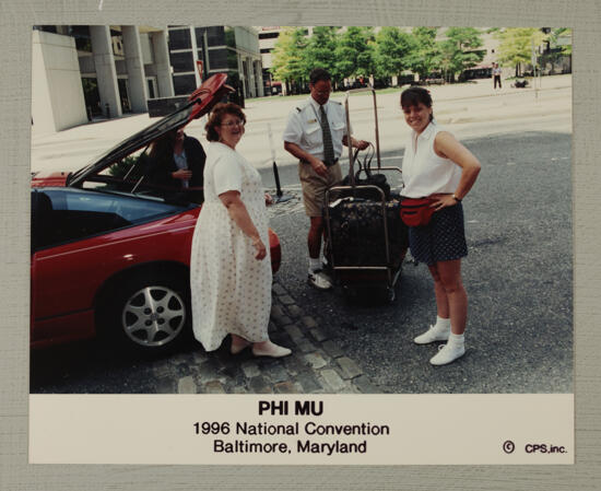 Elizabeth King and Others Unloading Luggage at Convention Photograph, July 4-8, 1996 (image)