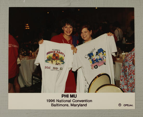 Two Phi Mus Displaying T-Shirts at Convention Photograph, July 4-8, 1996 (image)