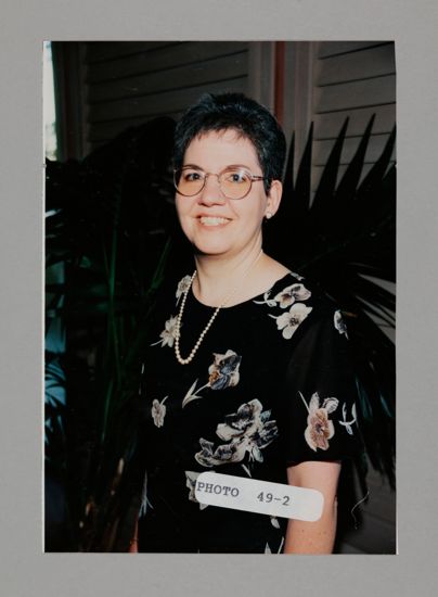 Unidentified Phi Mu in Flowered Dress at Convention Photograph, July 3-5, 1998 (image)