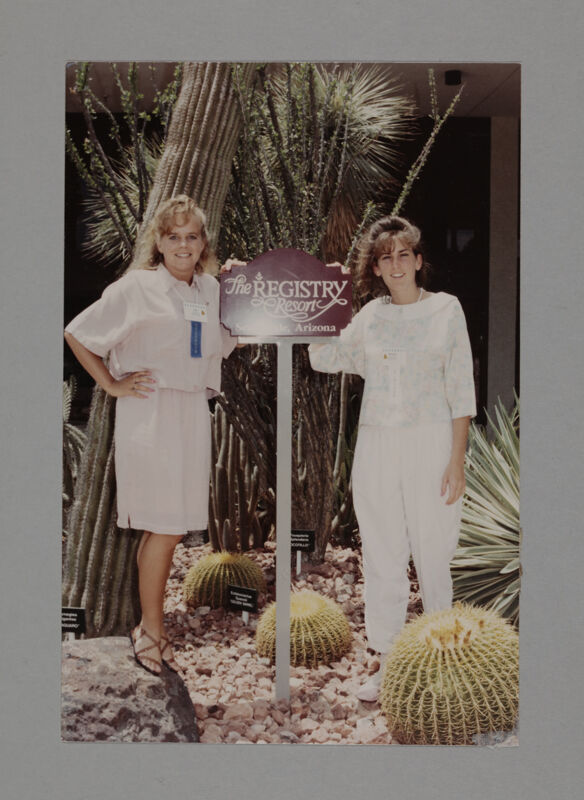 Two Phi Mus by Resort Sign at Convention Photograph, July 6-9, 1990 (Image)