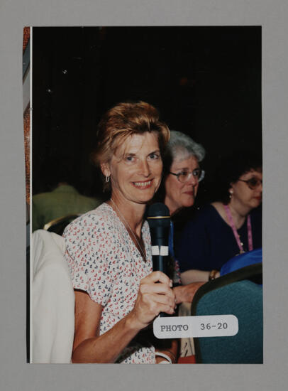 Unidentified Phi Mu with Microphone at Convention Photograph, July 3-5, 1998 (image)