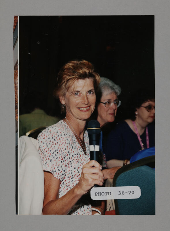Unidentified Phi Mu with Microphone at Convention Photograph, July 3-5, 1998 (Image)