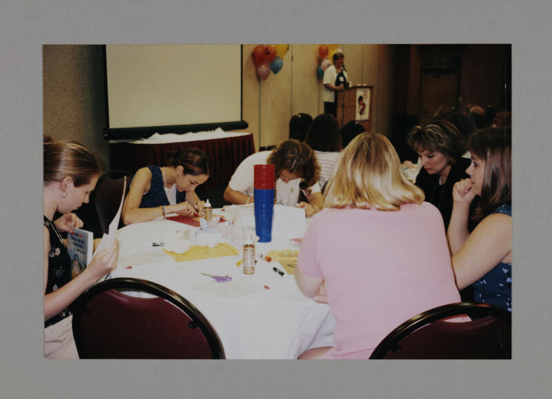 Phi Mus Working on Crafts at Convention Philanthropy Party Photograph, July 3-5, 1998 (Image)