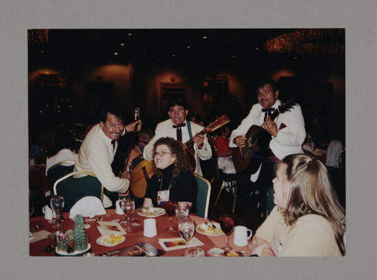 Rosalind Roland Serenaded by Guitar Players at Convention Foundation Luncheon Photograph, July 3-5, 1998 (image)