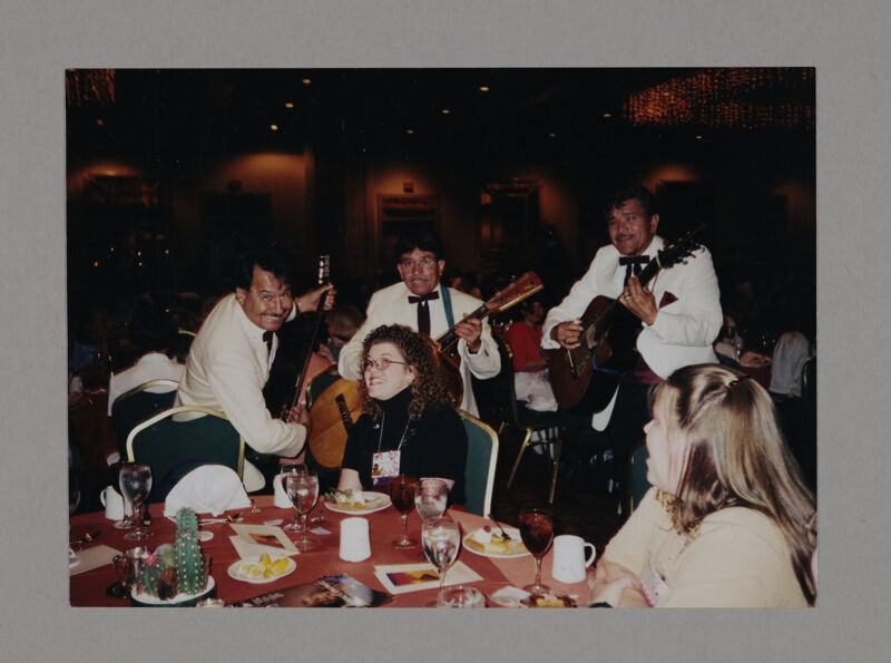 Rosalind Roland Serenaded by Guitar Players at Convention Foundation Luncheon Photograph, July 3-5, 1998 (Image)