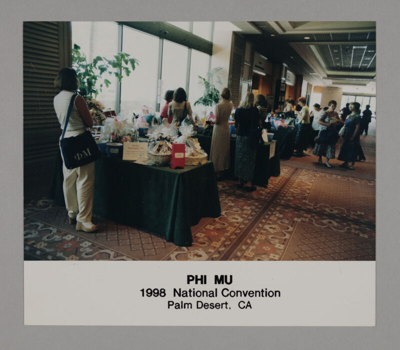 Phi Mus Looking Over Convention Treasure Baskets Photograph, July 3-5, 1998 (Image)