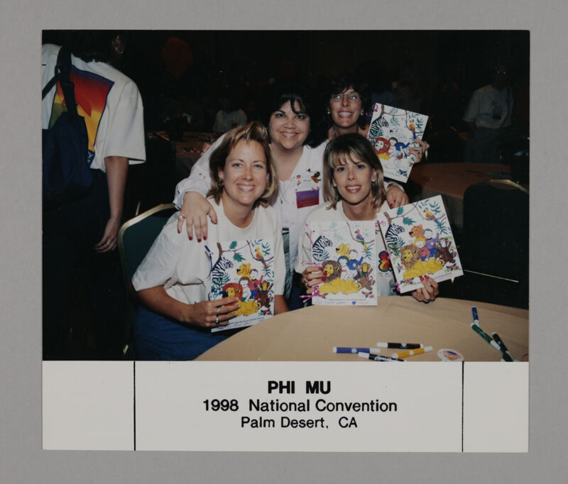 Four Phi Mus with Pictures at Convention Philanthropy Party Photograph, July 3-5, 1998 (Image)