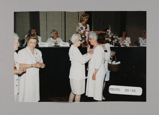 Polly Freear Pinning Unidentified Phi Mu at Convention Photograph, July 3-5, 1998 (image)