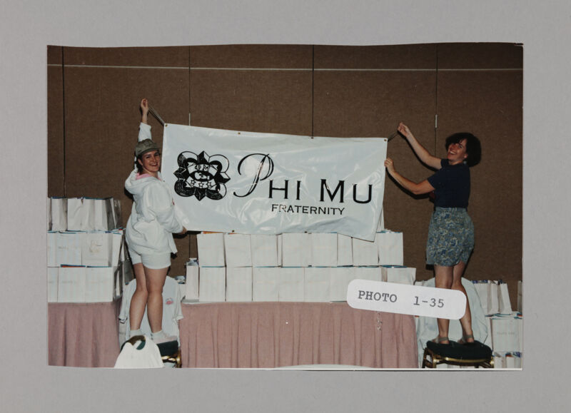 Two Phi Mus Hanging Banner at Convention Photograph, July 3-5, 1998 (Image)