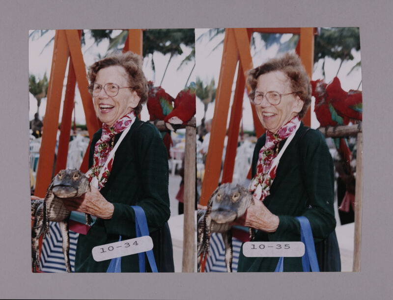 Marion Phillips Holding Crocodile at Convention Opening Dinner Photosheet, July 7-10, 2000 (Image)