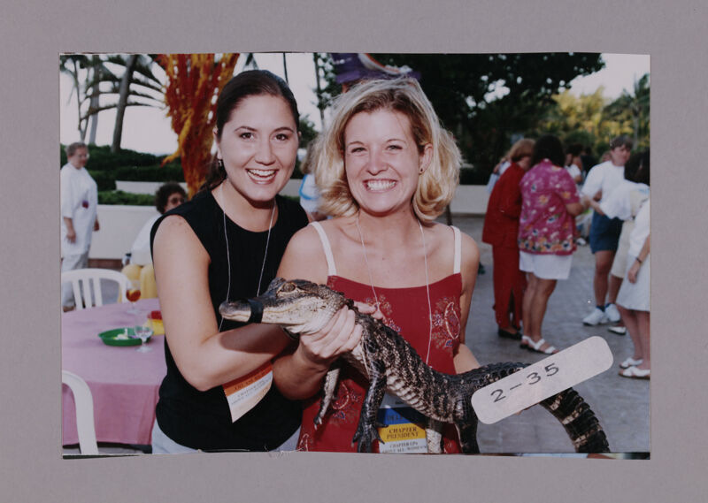 July 7-10 Two Phi Mus Holding Crocodile at Convention Opening Dinner Photograph 1 Image