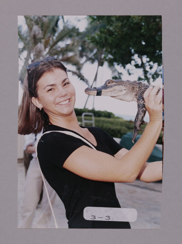 Unidentified Phi Mu Holding Crocodile at Convention Opening Dinner Photograph, July 7-10, 2000 (Image)
