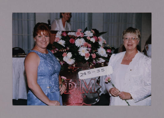 Molly Sanders and Mother by Convention Ice Sculpture Photograph, July 7-10, 2000 (image)