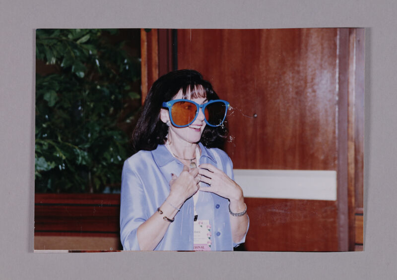 Barbara Little Wearing Oversized Sunglasses at Convention Photograph 1, July 7-10, 2000 (Image)