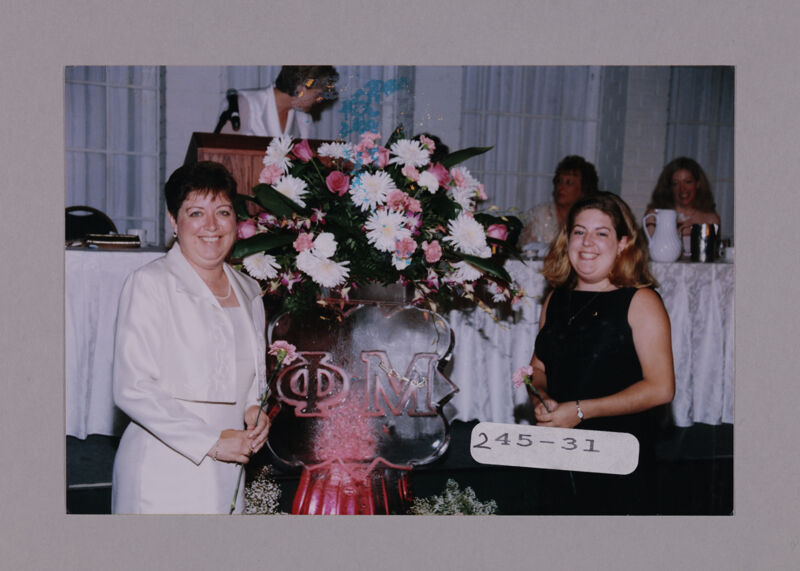 Susie McNamara and Daughter by Convention Ice Sculpture Photograph, July 7-10, 2000 (Image)
