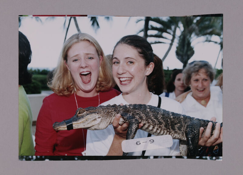 July 7-10 Two Phi Mus Holding Crocodile at Convention Opening Dinner Photograph 2 Image