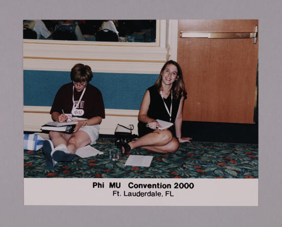 Unidentified and Rachel May Sitting on Floor at Convention Photograph, July 7-10, 2000 (image)