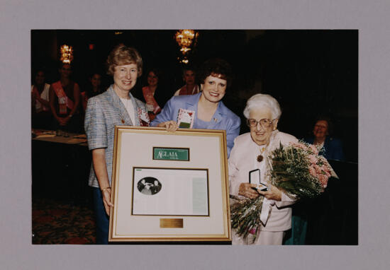 Stone, Garland, and Hughes with Framed Aglaia Issue at Convention Photograph, July 7-10, 2000 (image)