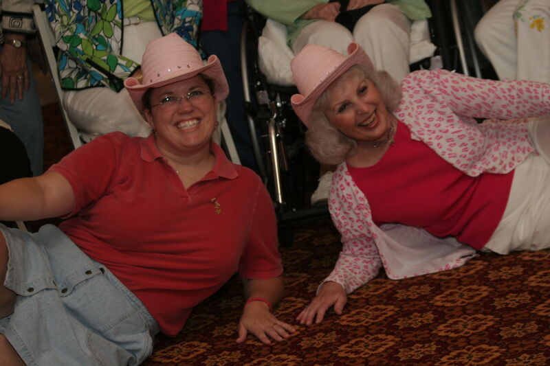 Two Unidentified Phi Mus in Pink Hats at Convention 1852 Dinner Photograph, July 14, 2006 (Image)