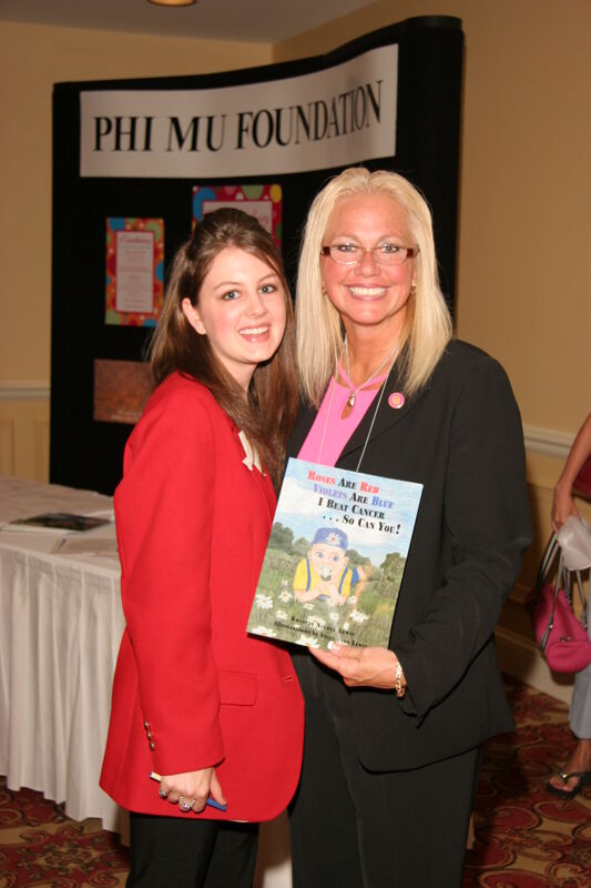 Two Unidentified Phi Mus With Children's Book at Convention Photograph, July 2006 (Image)