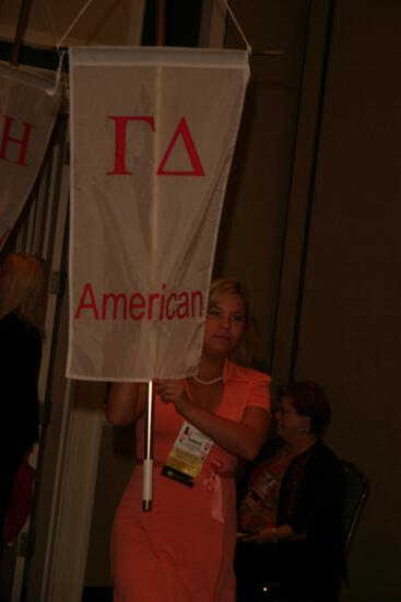 Laura Goodell with Gamma Delta Chapter Flag in Convention Parade Photograph 1, July 2006 (image)