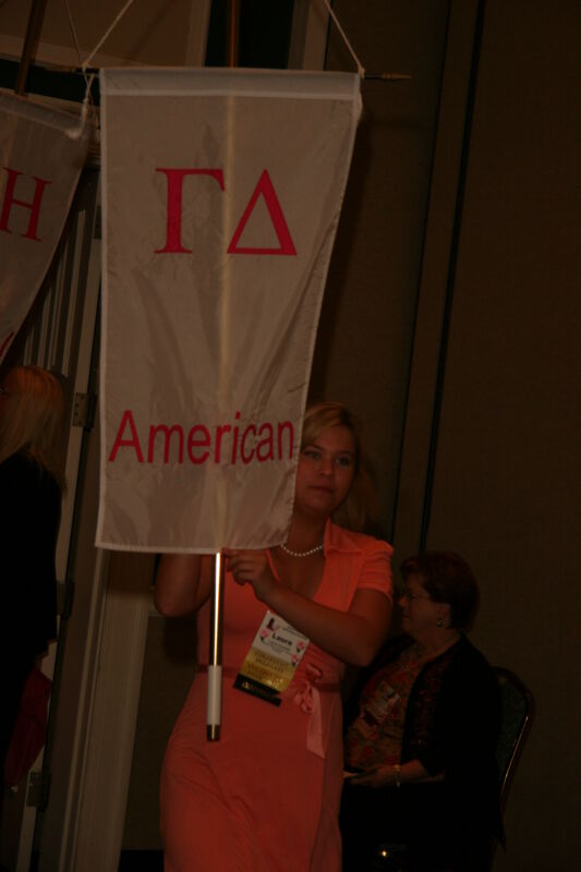 Laura Goodell with Gamma Delta Chapter Flag in Convention Parade Photograph 1, July 2006 (Image)