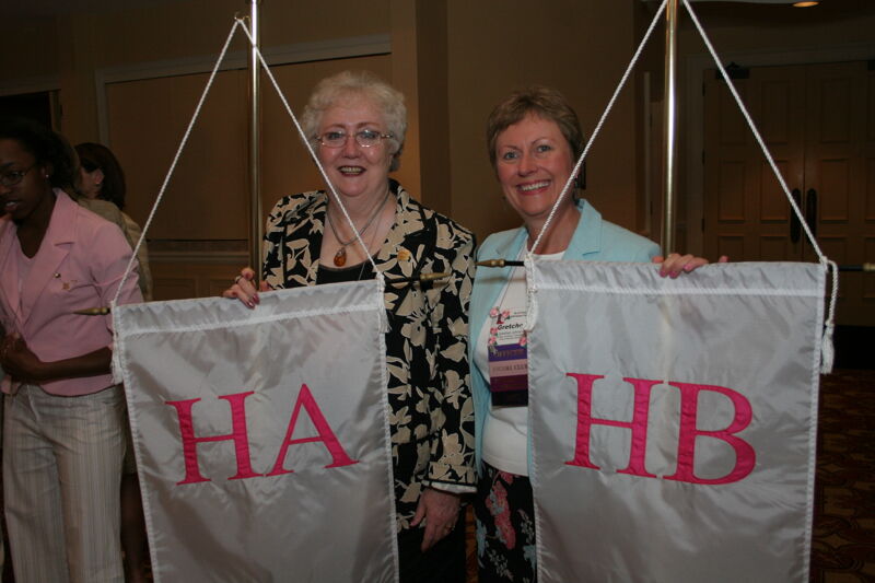 Claudia Nemir and Gretchen Johnson With Chapter Flags at Convention Photograph, July 2006 (Image)