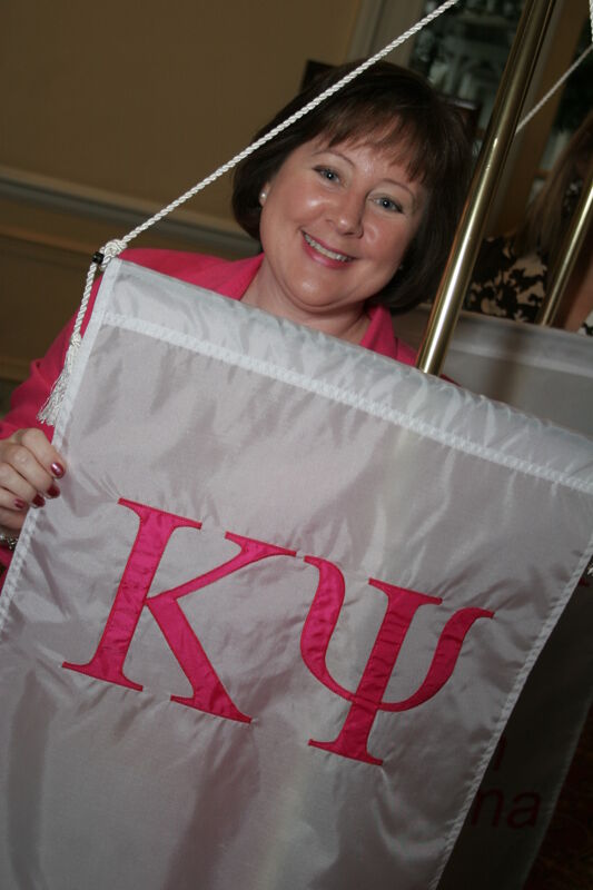 Robin Benoit With Kappa Psi Chapter Flag at Convention Photograph, July 2006 (Image)