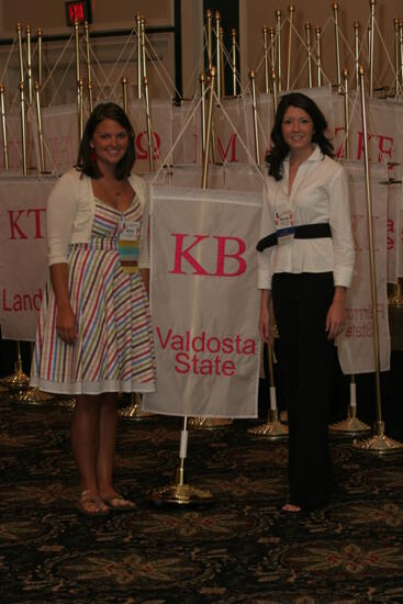 Kirby and Mandy by Kappa Beta Chapter Flag at Convention Photograph 1, July 2006 (image)