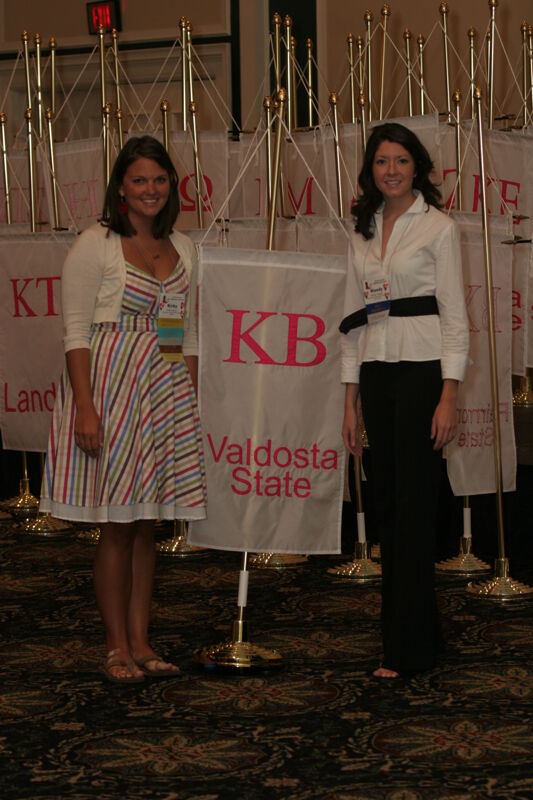 Kirby and Mandy by Kappa Beta Chapter Flag at Convention Photograph 1, July 2006 (Image)