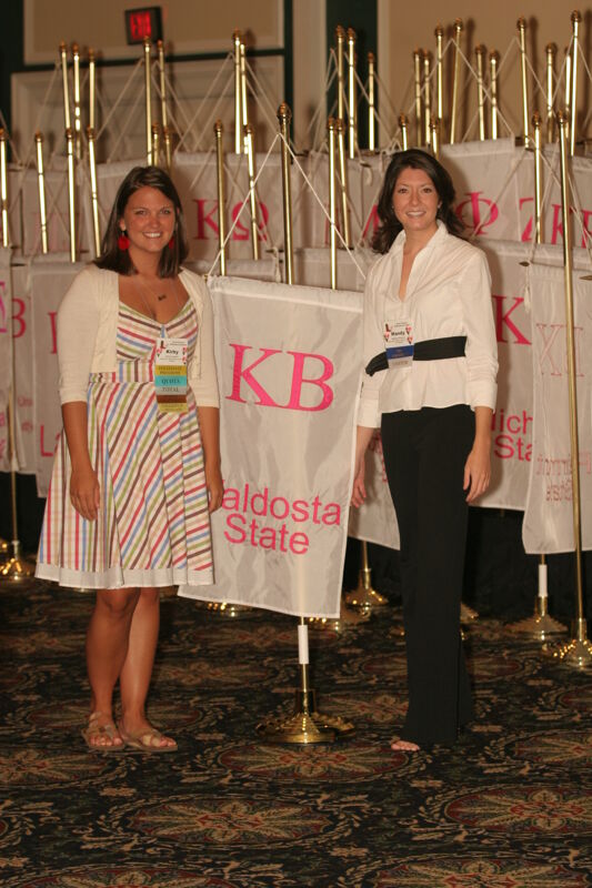 Kirby and Mandy by Kappa Beta Chapter Flag at Convention Photograph 2, July 2006 (Image)