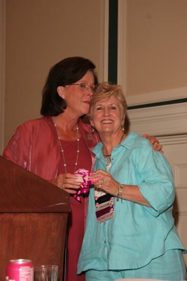 Shellye McCarty Presenting Gift to Sharon Staley at Friday Convention Session Photograph, July 14, 2006 (image)