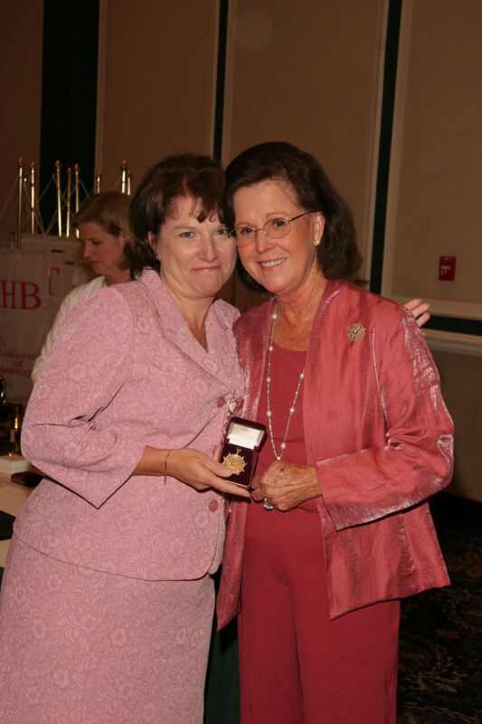 Shellye McCarty and Frances Mitchelson With Pin at Friday Convention Session Photograph, July 14, 2006 (Image)