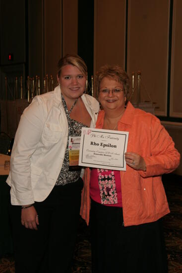 Kathy Williams and Rho Epsilon Chapter Member With Certificate at Friday Convention Session Photograph 1, July 14, 2006 (image)