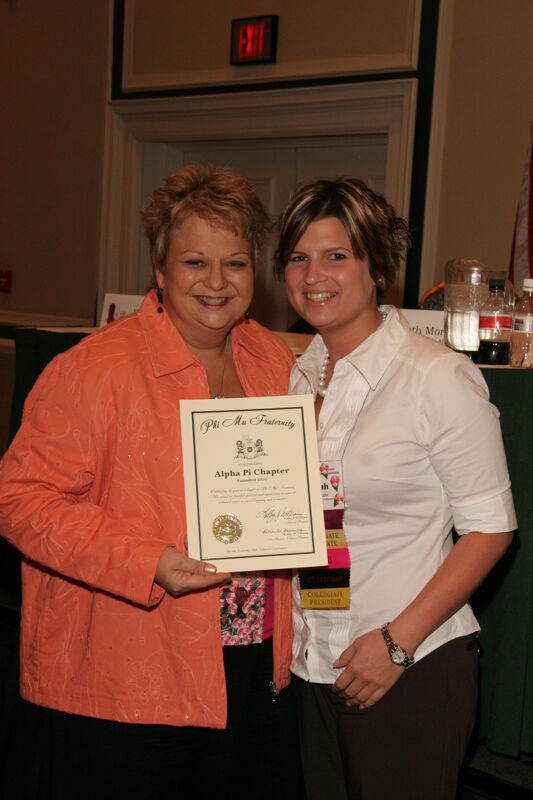 Kathy Williams and Alpha Pi Chapter Member With Certificate at Friday Convention Session Photograph 1, July 14, 2006 (Image)