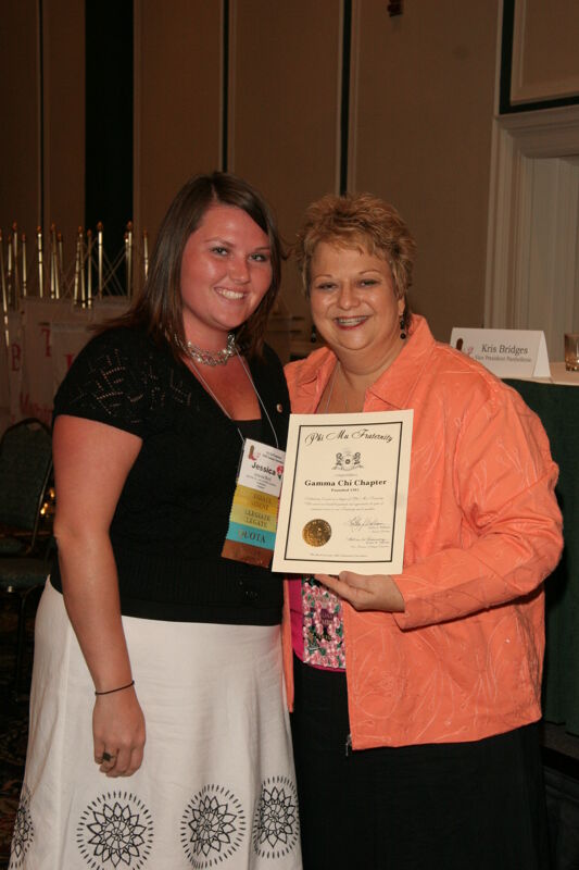 July 14 Kathy Williams and Gamma Chi Chapter Member With Certificate at Friday Convention Session Photograph Image