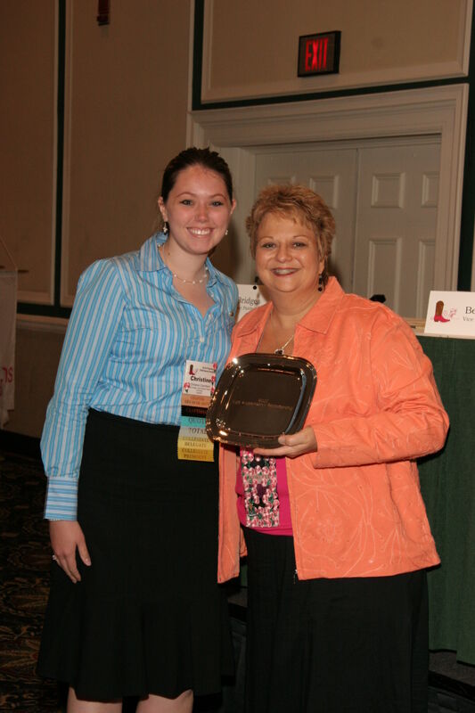 Kathy Williams and Delta Omega Chapter Member With Award at Friday Convention Session Photograph 2, July 14, 2006 (Image)